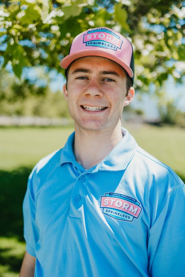 Smiling Storm Sprinklers technician ready to book your summer sprinkler tune-up