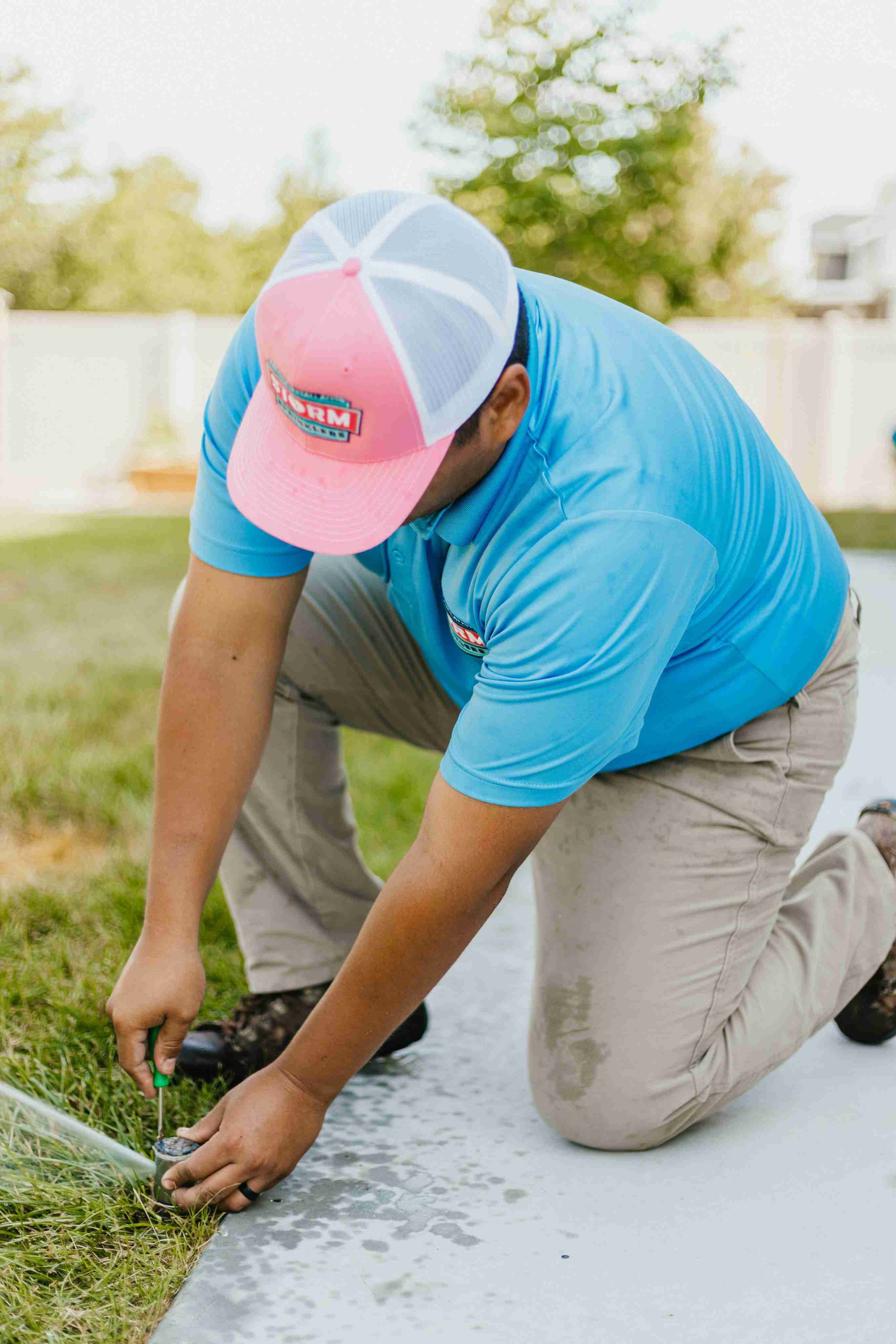 Storm Sprinklers technician adjusting sprinkler head during Utah lawn irrigation inspection