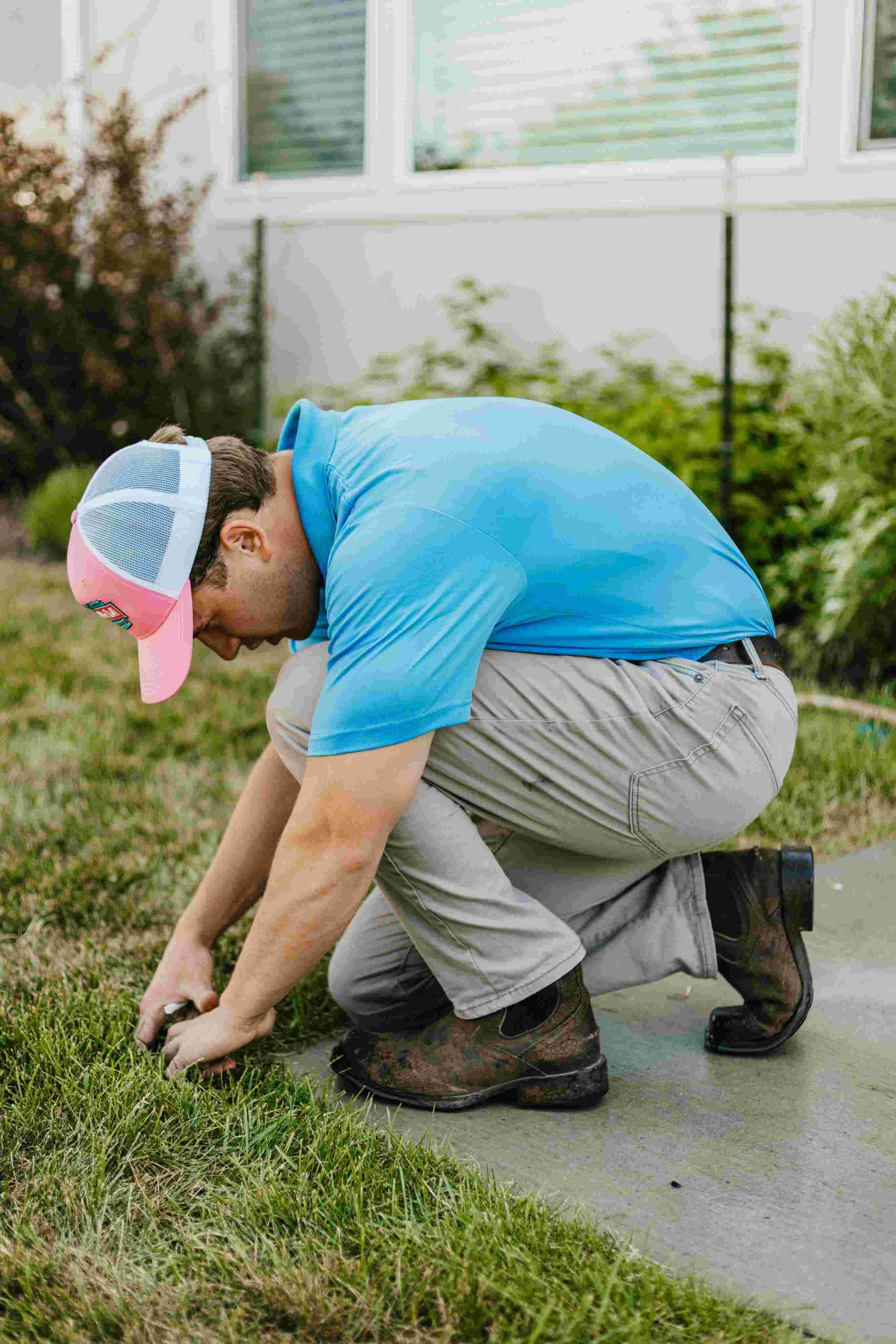 Sprinkler repair technician performing residential irrigation repairs in Utah County