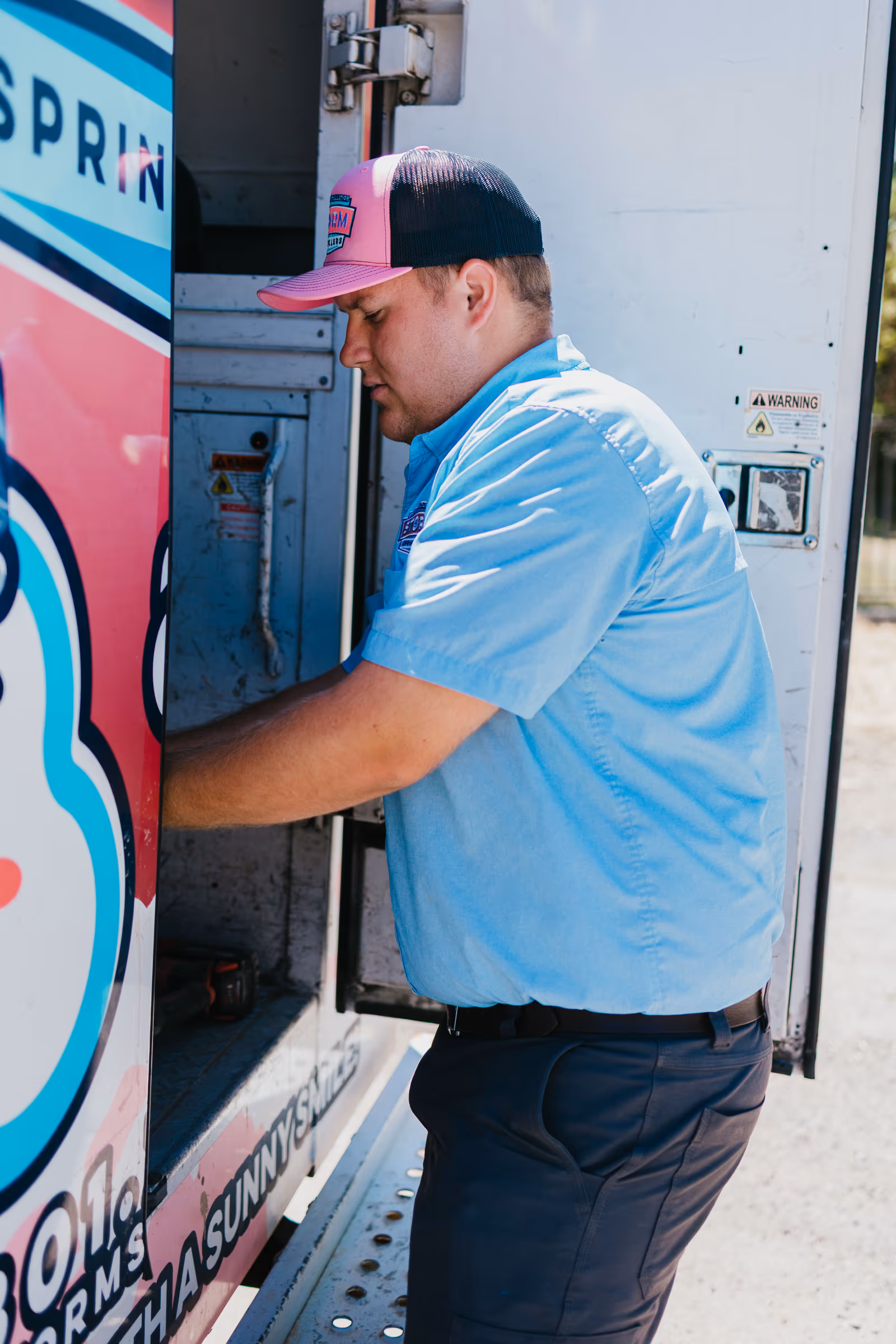 Storm Sprinklers technician retrieving winterization equipment from a service van